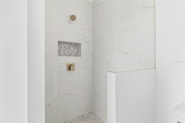 bathroom with a tile shower