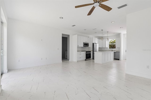 unfurnished living room featuring ceiling fan