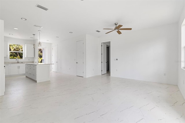 unfurnished room with ceiling fan and sink