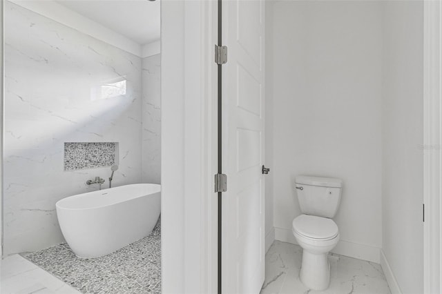 bathroom featuring a tub and toilet