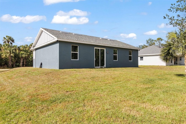 back of property featuring a lawn