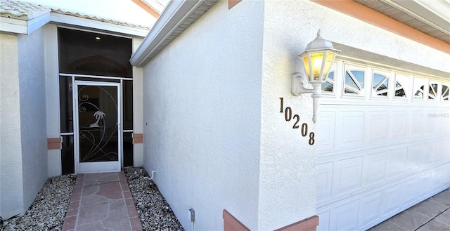 doorway to property featuring a garage