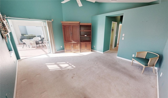 interior space featuring high vaulted ceiling and light colored carpet