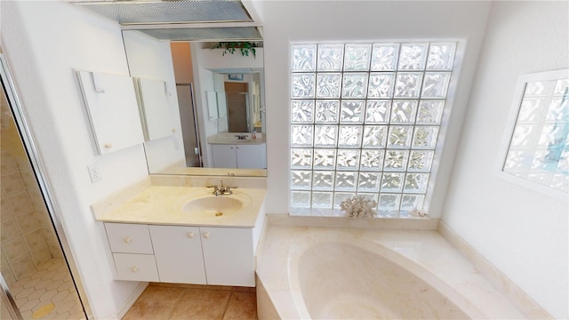 bathroom with tile patterned floors, vanity, and shower with separate bathtub