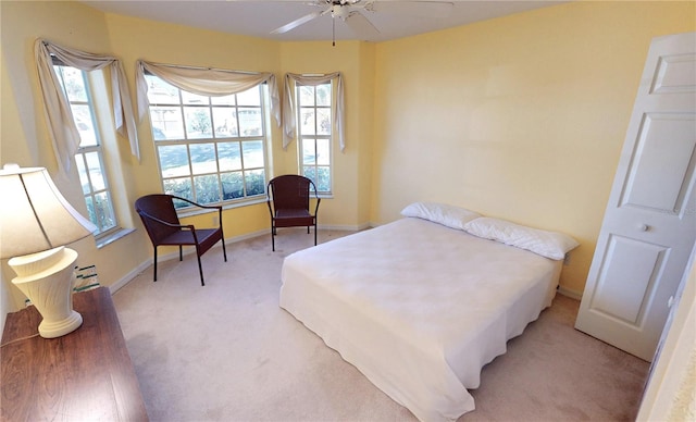 bedroom with light colored carpet and ceiling fan