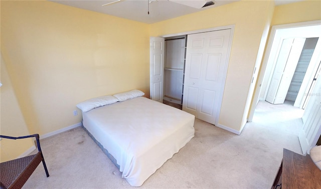 bedroom featuring a closet, light colored carpet, and ceiling fan