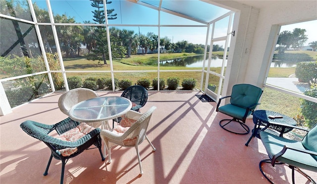 sunroom / solarium with a water view