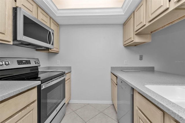 kitchen with sink, light brown cabinets, a tray ceiling, light tile patterned floors, and appliances with stainless steel finishes