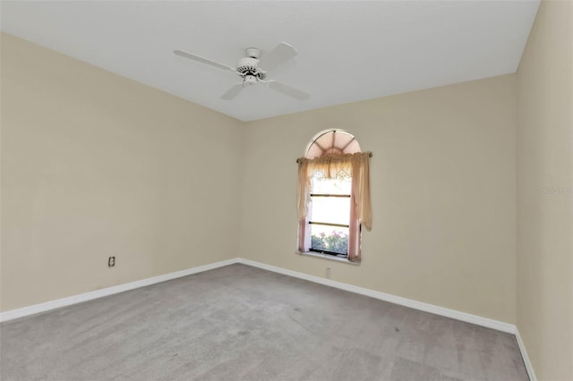 empty room featuring light colored carpet and ceiling fan