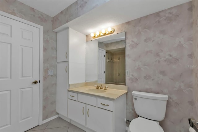 bathroom featuring toilet, vanity, and tile patterned floors