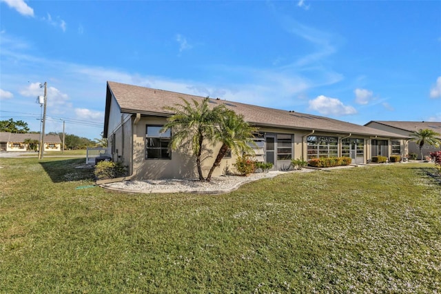 rear view of property with a lawn