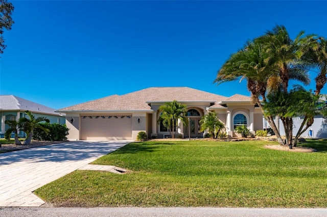 view of front of house with a garage and a front lawn