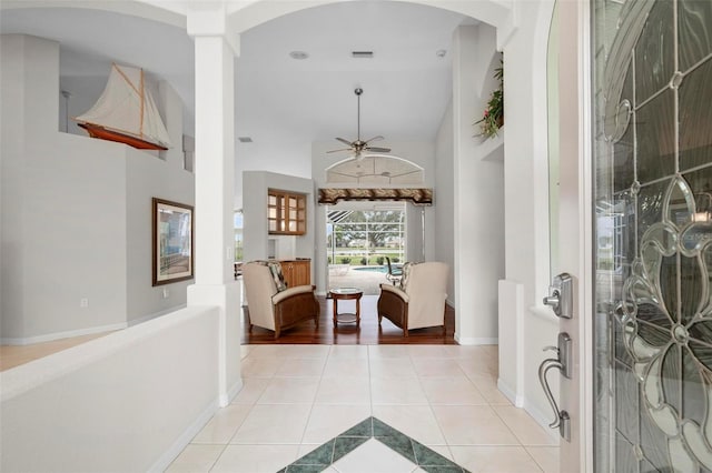 13028 SW Kingsway Cir, Lake Suzy, FL 34269 - entryway featuring light tile patterned flooring, arched walkways, ceiling fan, and high vaulted ceiling