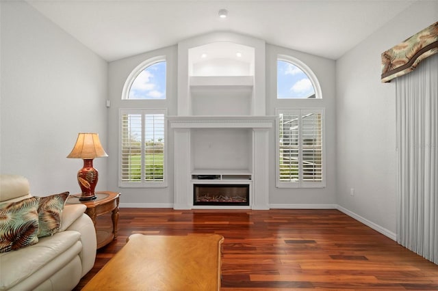 living room featuring dark hardwood / wood-style flooring and lofted ceiling