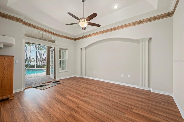 interior space with ceiling fan, wood-type flooring, and ornamental molding