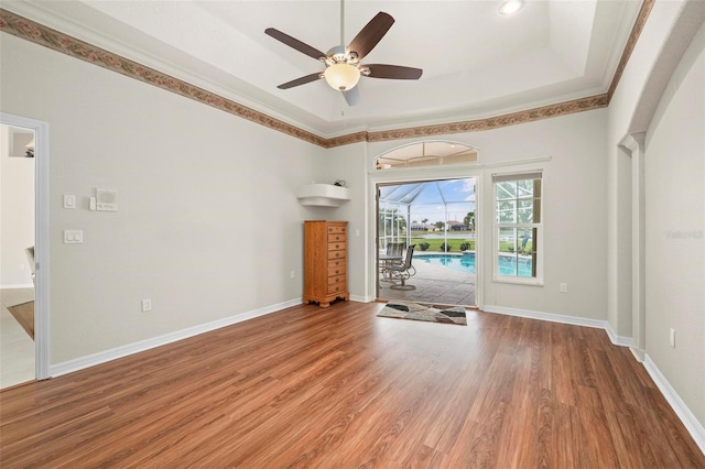 unfurnished living room featuring hardwood / wood-style floors, ceiling fan, and ornamental molding