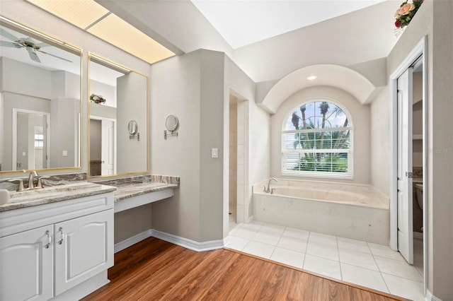 bathroom with ceiling fan, hardwood / wood-style floors, vanity, and plus walk in shower