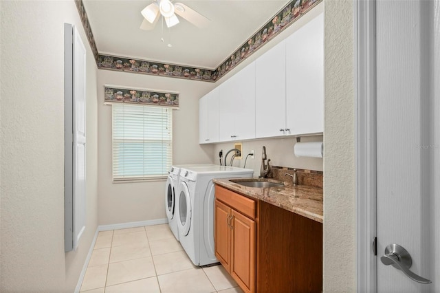 laundry room with washing machine and clothes dryer, ceiling fan, sink, cabinets, and light tile patterned floors