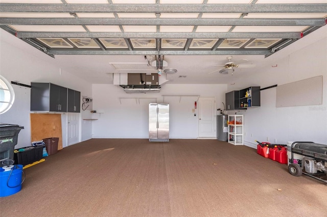 garage featuring ceiling fan, electric water heater, and a garage door opener