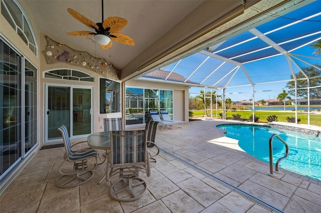 view of swimming pool featuring ceiling fan, a patio area, and a lanai