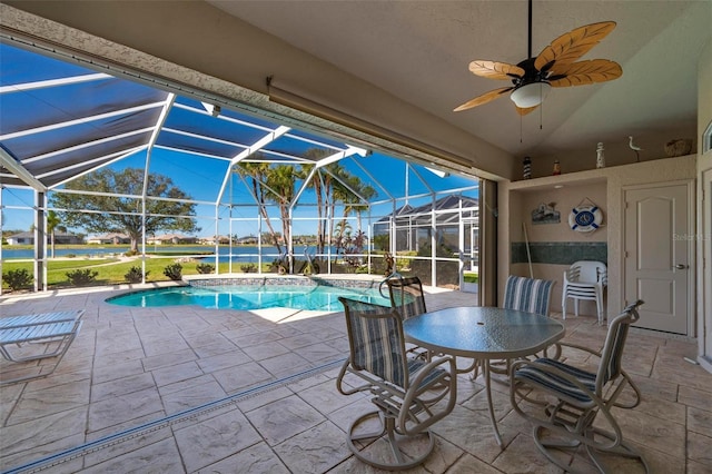 view of swimming pool featuring ceiling fan, a lanai, and a patio