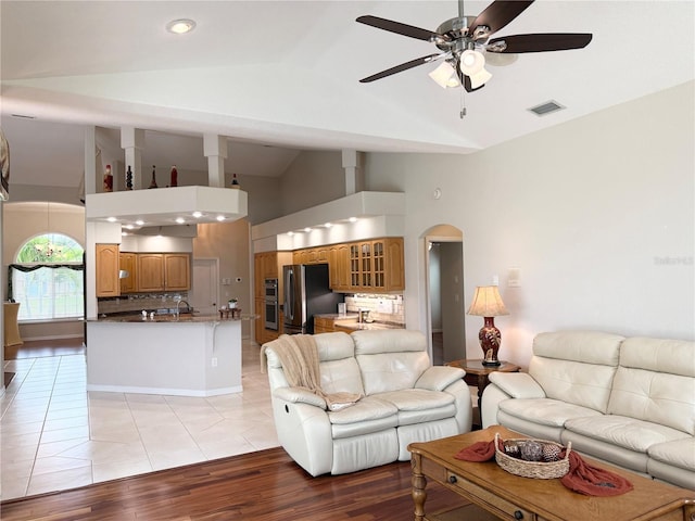 13028 SW Kingsway Cir, Lake Suzy, FL 34269 - living room with a ceiling fan, high vaulted ceiling, light wood-type flooring, arched walkways, and recessed lighting