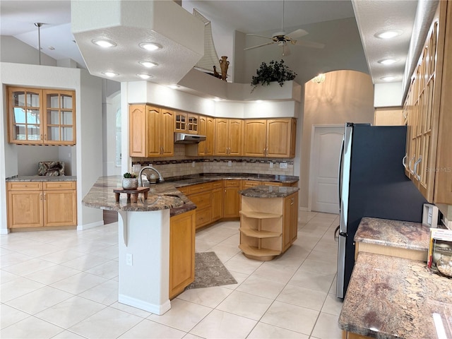 13028 SW Kingsway Cir, Lake Suzy, FL 34269 - kitchen with a peninsula, light tile patterned floors, tasteful backsplash, glass insert cabinets, and open shelves
