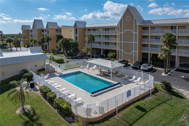 view of pool featuring central air condition unit and a patio