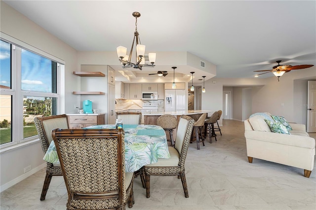 dining room featuring ceiling fan with notable chandelier