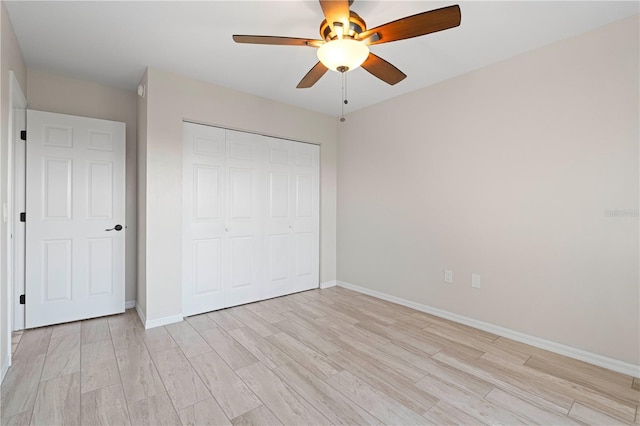 unfurnished bedroom with a closet, light hardwood / wood-style floors, and ceiling fan