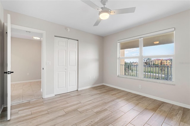 unfurnished bedroom featuring ceiling fan, a closet, and light hardwood / wood-style flooring