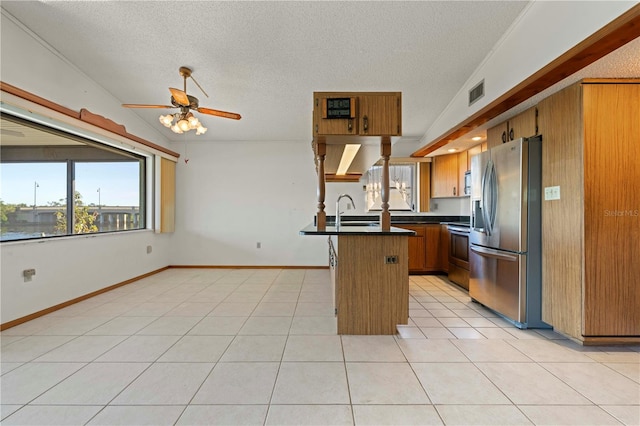 kitchen with stainless steel refrigerator with ice dispenser, stove, custom exhaust hood, ceiling fan, and lofted ceiling