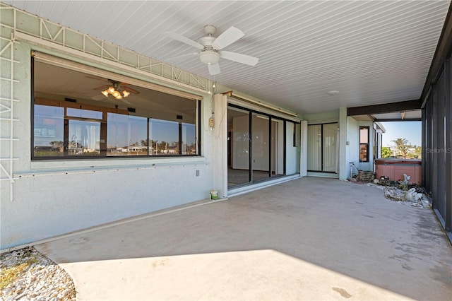 view of patio / terrace featuring ceiling fan and a hot tub