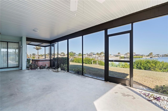 sunroom featuring a water view and a healthy amount of sunlight