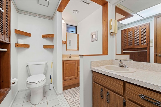 bathroom with tile patterned floors, vanity, and toilet