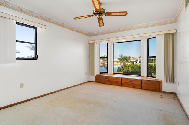 carpeted empty room with ceiling fan