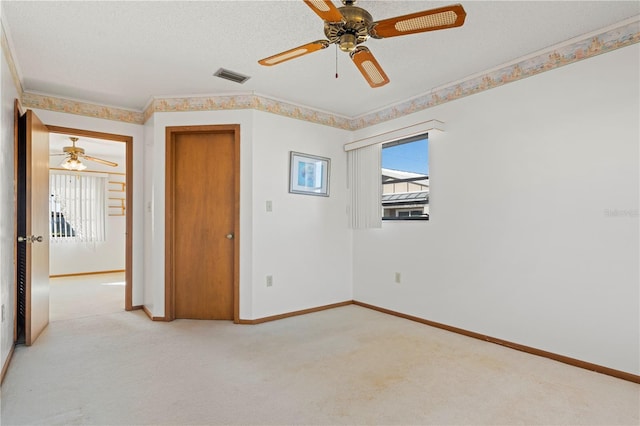 unfurnished bedroom featuring multiple windows, ceiling fan, and light colored carpet