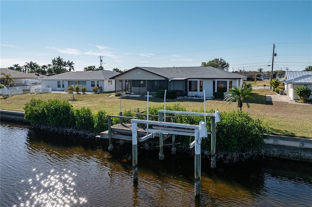 dock area featuring a lawn and a water view