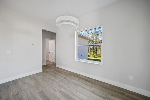 unfurnished room with light hardwood / wood-style flooring