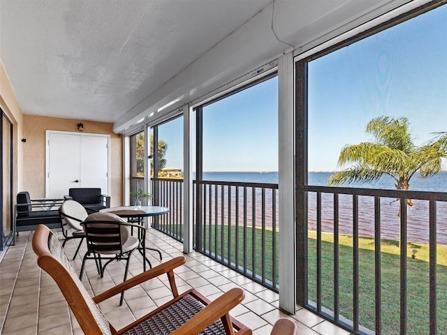 sunroom / solarium with a water view and a wealth of natural light