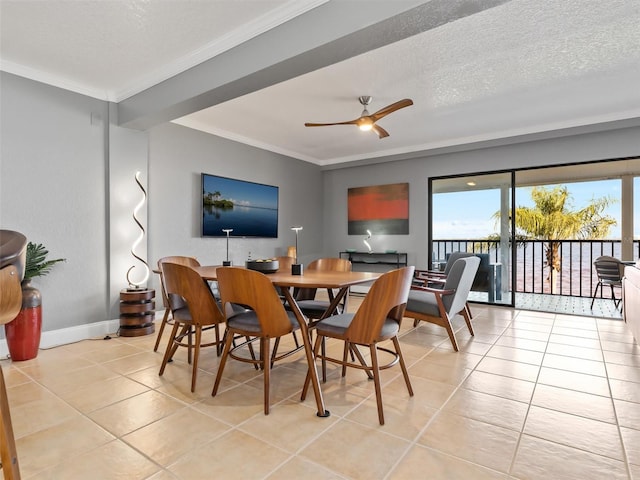 dining space featuring light tile patterned floors, a textured ceiling, ceiling fan, and ornamental molding