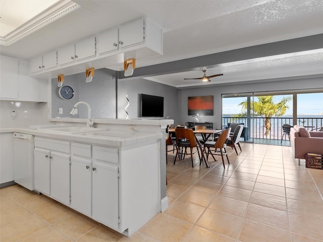 kitchen featuring white dishwasher, ceiling fan, white cabinetry, and sink