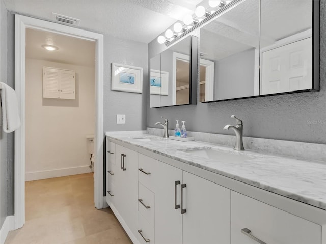 bathroom featuring vanity and a textured ceiling