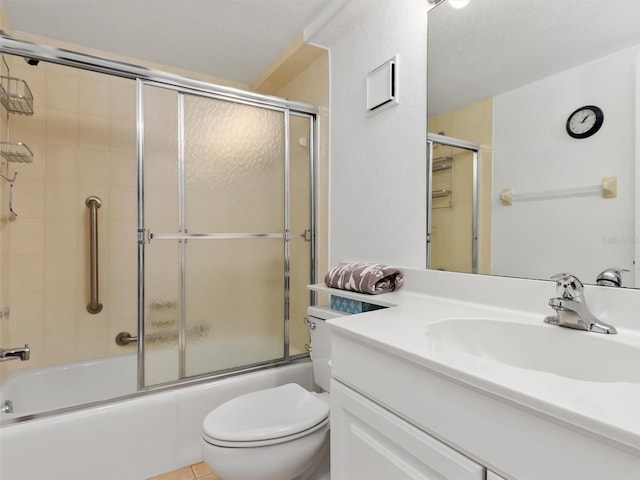 full bathroom featuring tile patterned flooring, vanity, toilet, and bath / shower combo with glass door