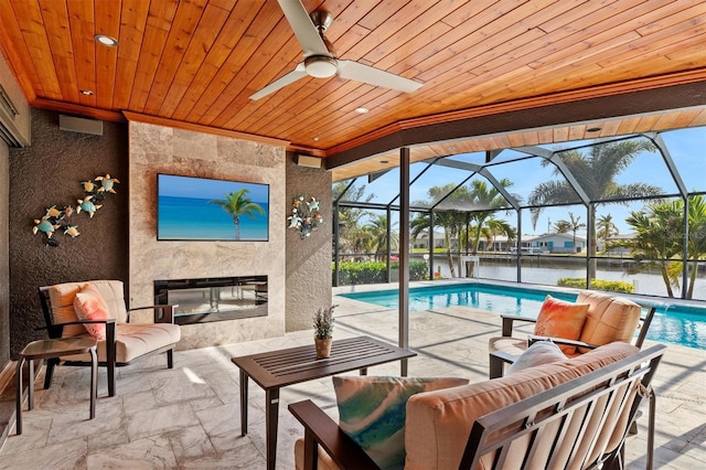 view of patio featuring an outdoor living space with a fireplace, ceiling fan, and a lanai