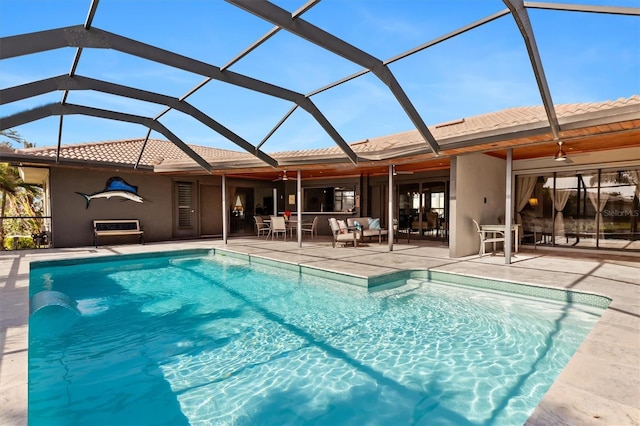 view of pool with ceiling fan, a patio area, a lanai, and an outdoor hangout area