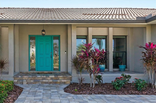 view of exterior entry with a porch