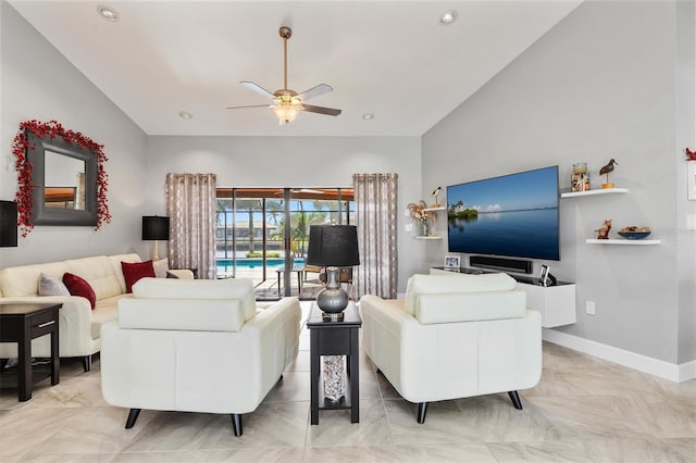 living room featuring ceiling fan and vaulted ceiling