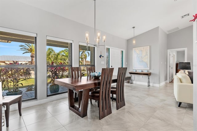 dining space with an inviting chandelier and lofted ceiling