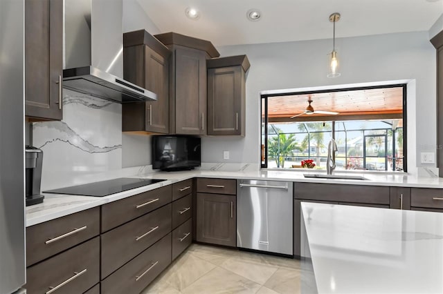 kitchen featuring light stone counters, stainless steel dishwasher, wall chimney exhaust hood, and sink